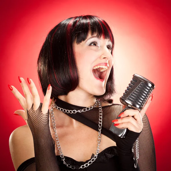 Cântăreață de epocă cu portret microfon pe fundal roșu — Fotografie, imagine de stoc
