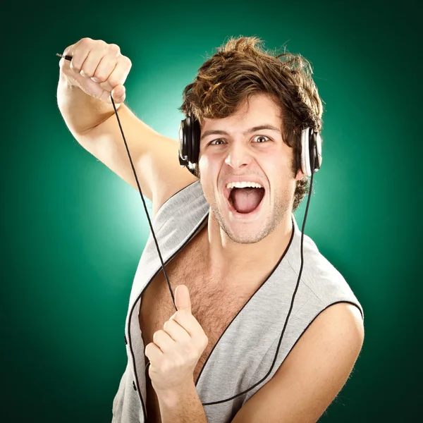 Crazy curly dj portrait on green background Royalty Free Stock Photos