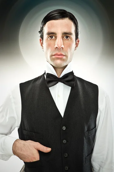 Serious butler with bow tie on grey background — Stock Photo, Image