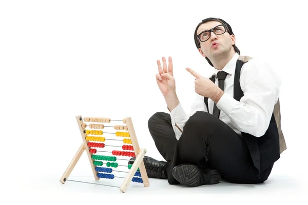 Grappige nerd man met een abacus geïsoleerd op wit — Stockfoto