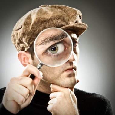 curious man look with magnifier glass on grey background clipart