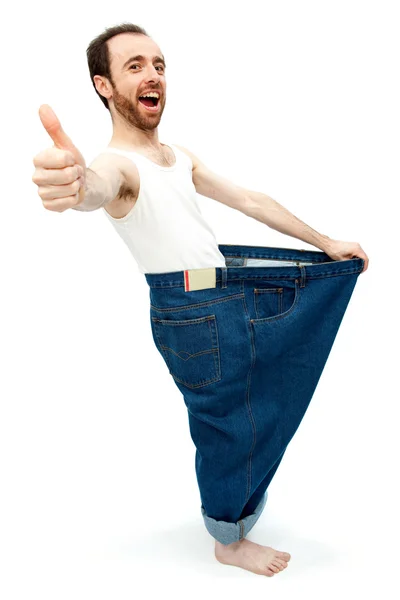 Rolig smal man med stora byxor jeans isolerad på vit — Stockfoto