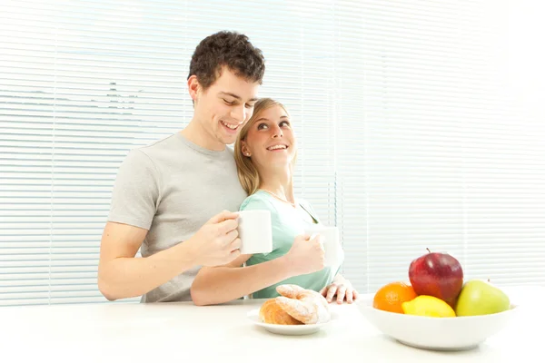 Young casual couple have breakfast with coffee and fruit with venetian blind window — Stock Photo, Image