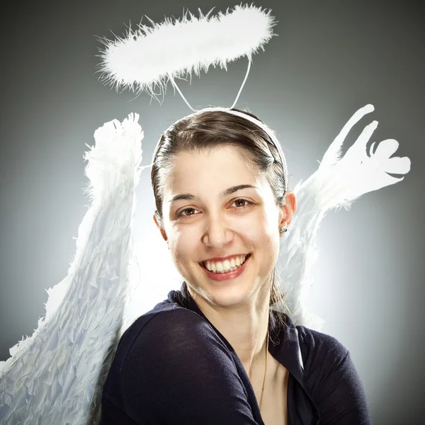 Sweet beautiful  angel young woman smile on grey background — Stock Photo, Image