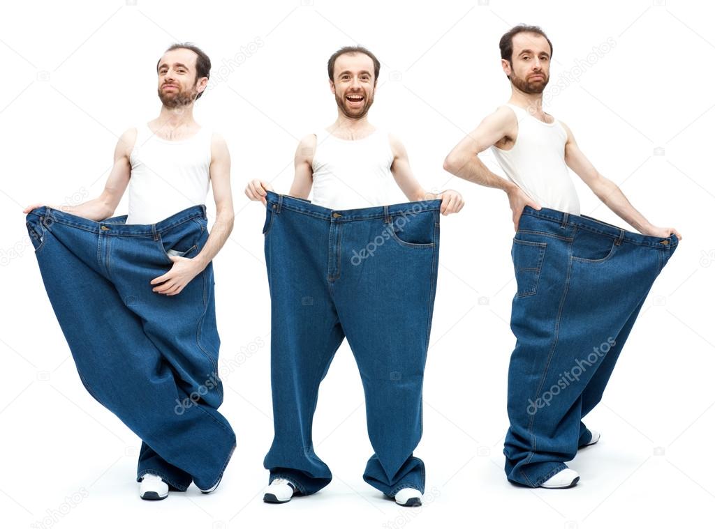 Funny slim man with large pants jeans isolated on white Stock Photo by