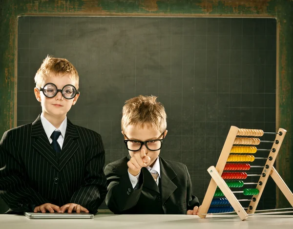 Young clever scientist children students with abacus and blackboard — Stock Photo, Image