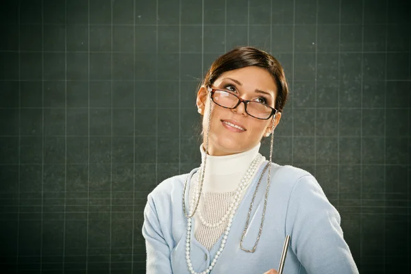 Mooie lachende jonge leraar met bril en blackbouard — Stockfoto