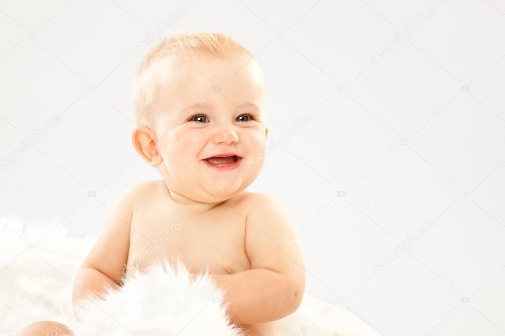 Beautiful Blonde Hair Blue Eyes Baby In A White Room Stock Photo