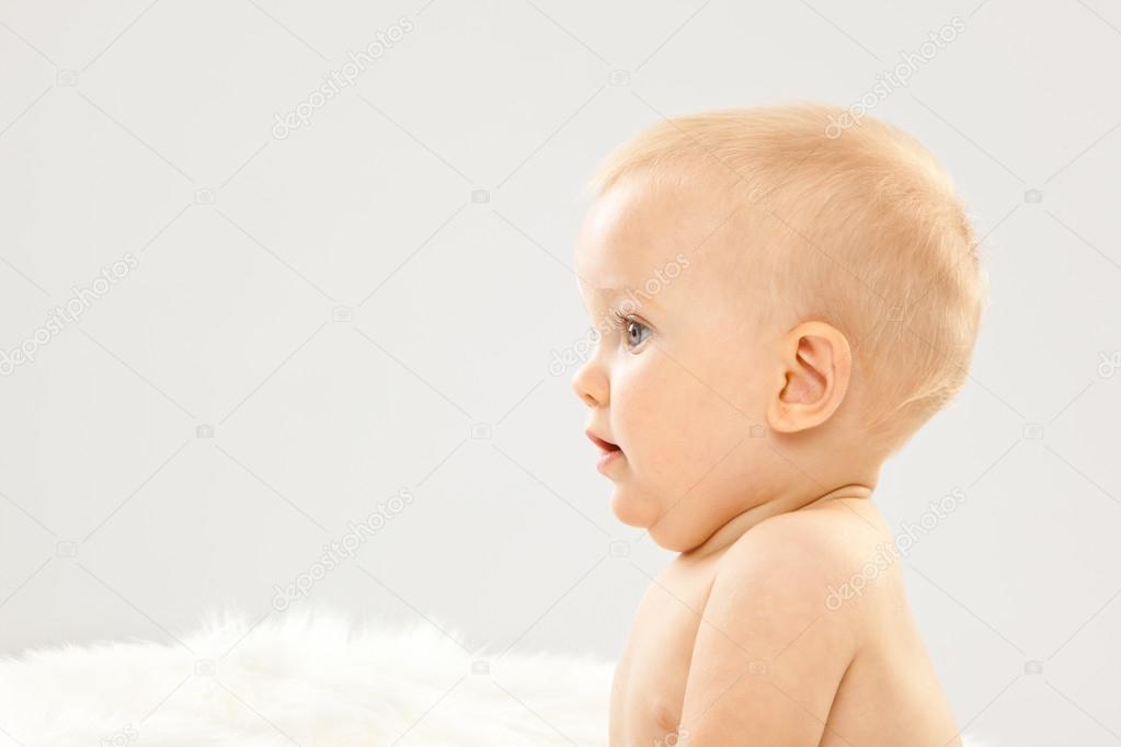 Beautiful Blonde Hair Blue Eyes Baby In A White Room Stock Photo