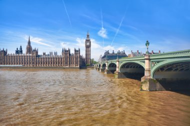 London westminster houses of parliament and bridge on river thames in a sunny day clipart