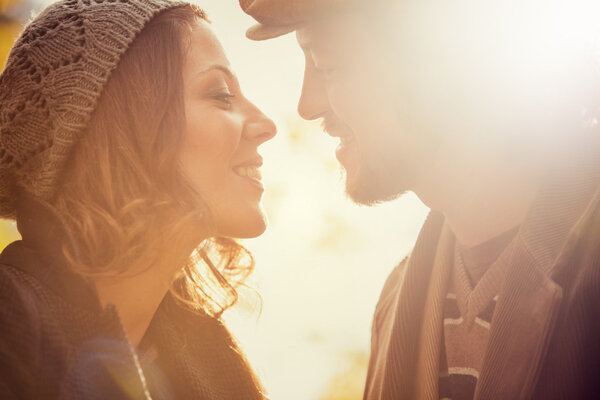 romantic couple in love at the park in autumn