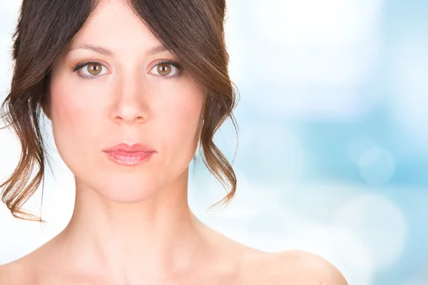 Serious brunette woman isolated on bright background — Stock Photo, Image