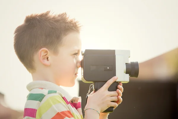 Spokojený úsměv blonďaté dítě hrát starou kamerou v parku — Stock fotografie