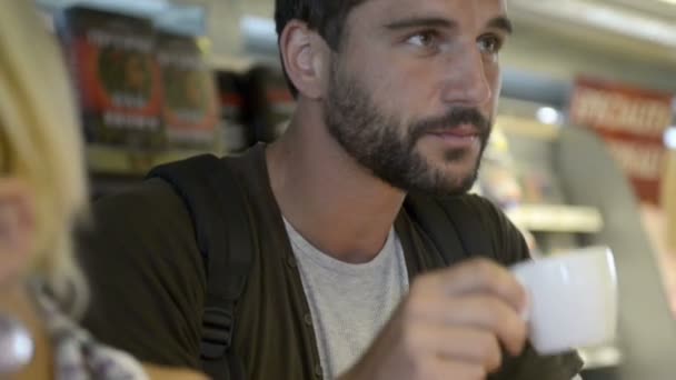 Young beautiful man has breakfast with cappuccino — Stockvideo