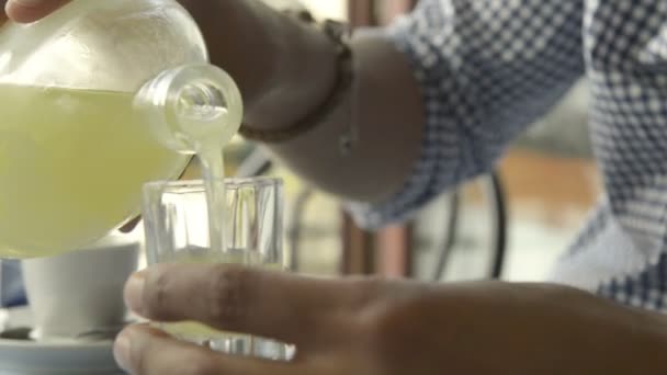 Young beautiful black man pour an italian lemon acoholic drink — Stock Video