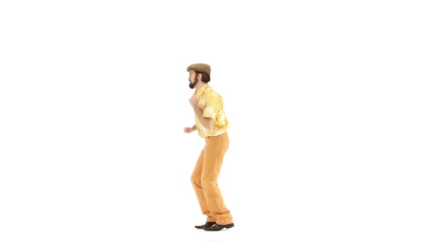 Young man dressing in 70s yellow-orange vintage clothes and hat  making movements — Stock Video