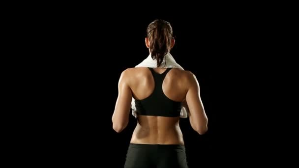 Спортсменка в спортивному одязі сушить білим рушником — стокове відео