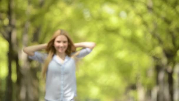 Young beautiful blonde girl in summer day walks — Stock Video