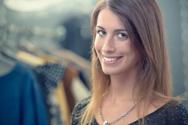 Jonge brunette vrouw Kies kleding in de winkel — Stockfoto