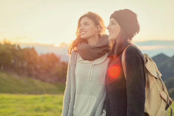 Young women looking at camera hug themselves in nature outdoor — Stock Photo, Image