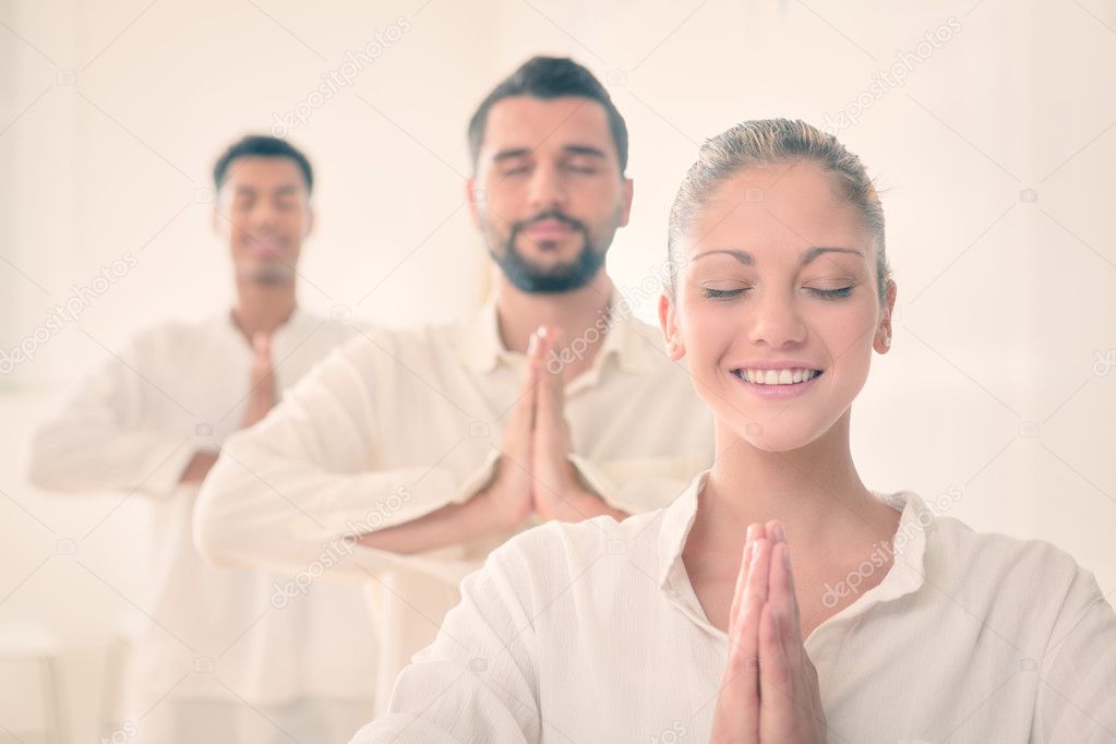 Group of people relax in a white gym 