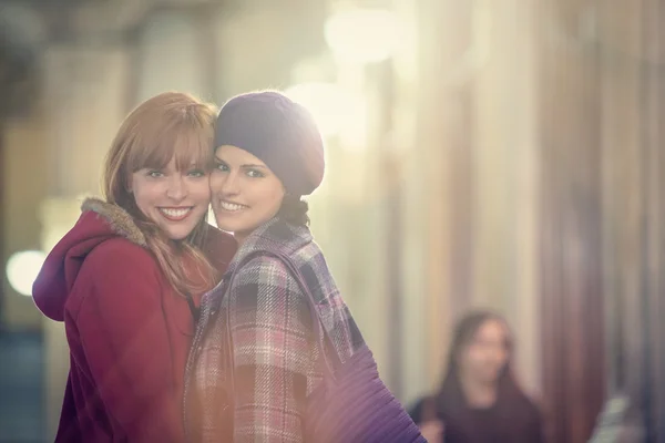 Women hugging each other and looking at camera — Stock Photo, Image