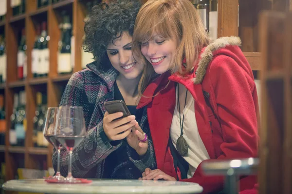 Women drinking red wine in pub — Stock Photo, Image