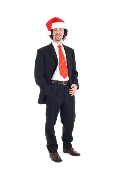 businessman with santa hat standing with hand in pokets