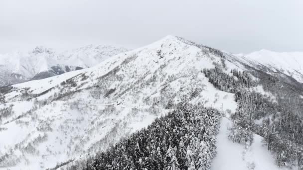 Aerial view of Cold Mountain Top Snow Ice Tourism Sport Eco Travel Mountains, Peaks Cliffs, Rocks Ridges,Landscape. Drone Aerial Flight Over Mountain Range in winter Nature. Slow Motion — Stock Video