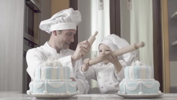 Père joue avec son fils après avoir fini les gâteaux. Mélodie de famille, partie de la série, garçons heureux joue avec rouleau à pâtisserie après avoir terminé deux gâteaux d'anniversaire — Video