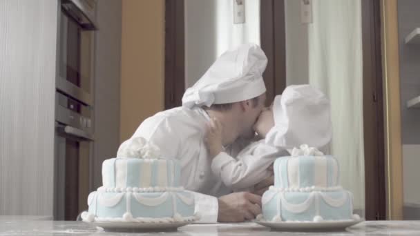 Father kisses his son after finished cakes. Family tune, son give a five to his father. Part of series, happy boys plays after completing two birthday cakes — Wideo stockowe