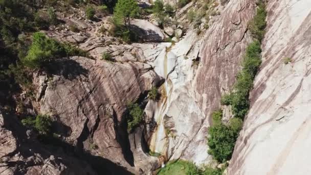 Uitzicht vanuit de lucht op kleine waterval, natuurlijk zwembad, bomen op de witte rots.Drone standpunt van de karakteristieke waterval in Corsica.Avontuurlijke en opgeleide mensen wandelen tijdens de zonnige zomerdag — Stockvideo