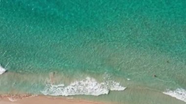 Deniz üzerindeki günbatımının havadan görüntüsü. Güzel deniz dalgaları. Pembe kum ve inanılmaz deniz. Yaz günbatımı deniz manzarası. Okyanus sahili gün batımı. Su dokusu. Fantastik doğal fenomenin en üst görüntüsü.