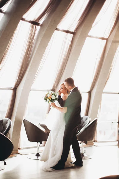 Casamento casal está de pé e beijando no hotel — Fotografia de Stock