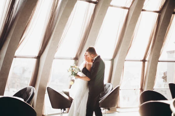 Hochzeitspaar steht und küsst sich im Hotel — Stockfoto