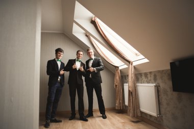 Mutlu arkadaş yardımcı olur şık damat onun düğün günü için hazırlanıyor