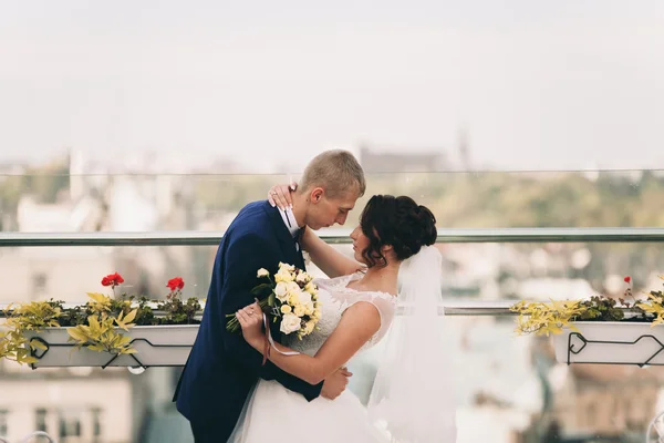 Joyeux mariage couple, mariée, marié baisers avec vue sur la vieille ville — Photo