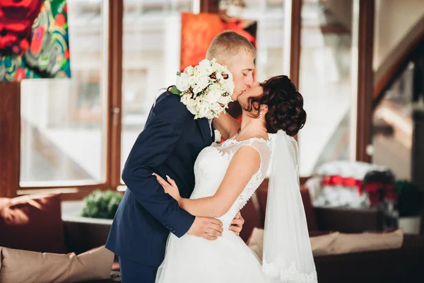 Glückliches Hochzeitspaar, Braut und Bräutigam posieren im Hotel — Stockfoto