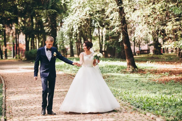 Щаслива весільна пара, наречена і наречений позує в парку — стокове фото