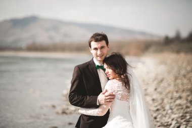 Mutlu yeni evliler, gelin ve damat nehir manzarası ile poz