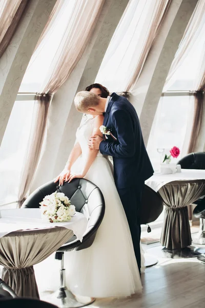 Verheugd huwelijksfeest paar, bruid en bruidegom poseren in hotel — Stockfoto