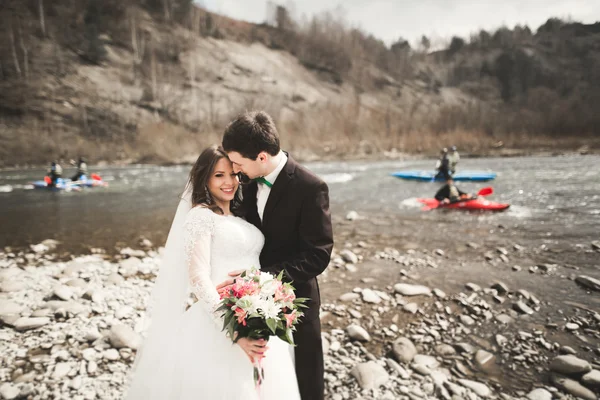 幸福的新婚夫妇，新娘和新郎摆整齐河山脉的背景 — 图库照片