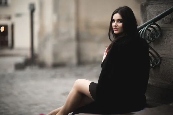 Vacker brunett ung kvinna poserar på gatan i gamla staden — Stockfoto