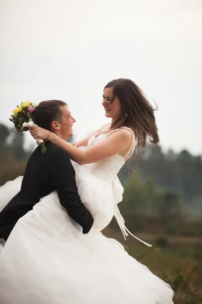 Елегантна красива весільна пара позує біля озера в парку — стокове фото