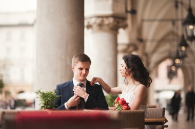 Çift, düğün, gülümseyen ve öpüşme kafede oturan kız