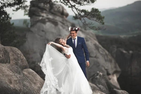 Casal lindo beijando e abraçando perto das falésias com vistas deslumbrantes — Fotografia de Stock