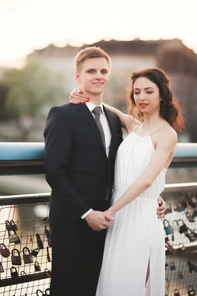 Gorgeous wedding couple, bride and groom posing on bridge in Krakow — Stock Photo, Image