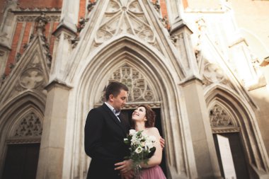 Muhteşem Düğün çifti, damat ve gelin pembe elbise Krakow eski şehirde yürüyüş ile