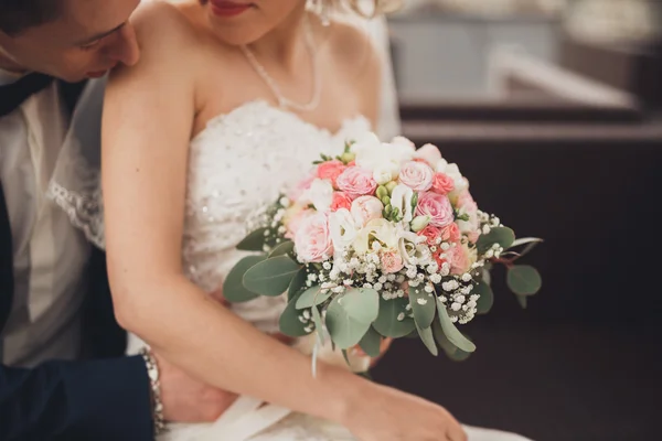 Pretty good wedding bouquet of various flowers in hand — Stock Photo, Image