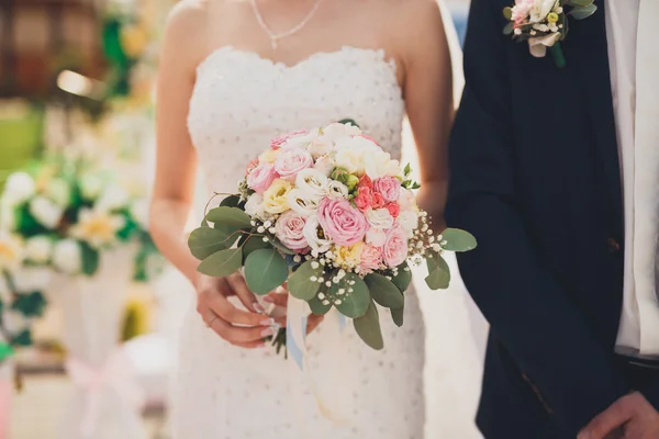 Pretty good wedding bouquet of various flowers in hand — Stock Photo, Image